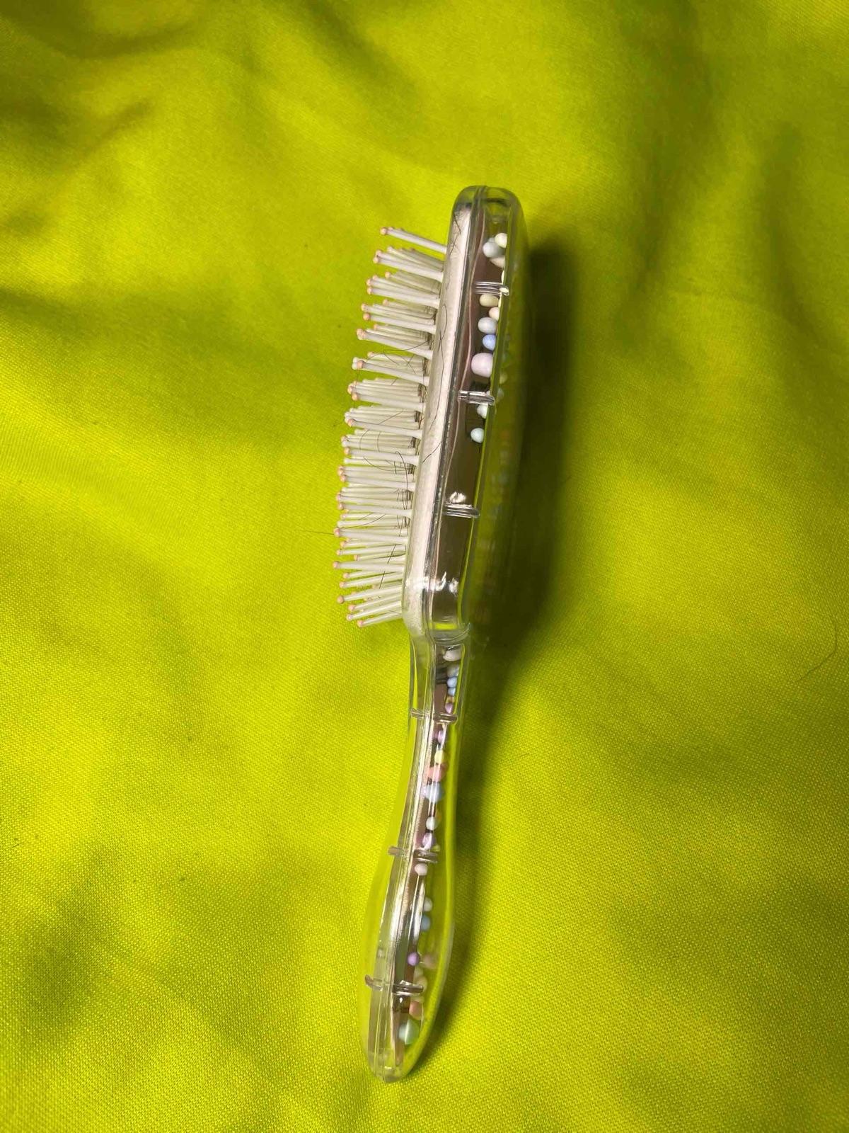 Cepillo de cabello transparente con diseño parisino y bolitas decorativas, foto 2 de 2